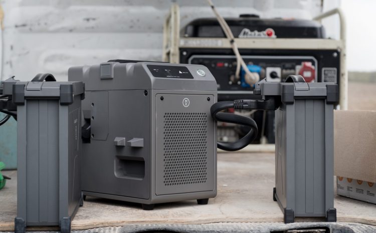 TERNOPIL REGION, UKRAINE - May 06, 2023 - the process of charging with a charging station of two agrodrone sprayer DJI AGRAS T30 batteries from a generator in the field